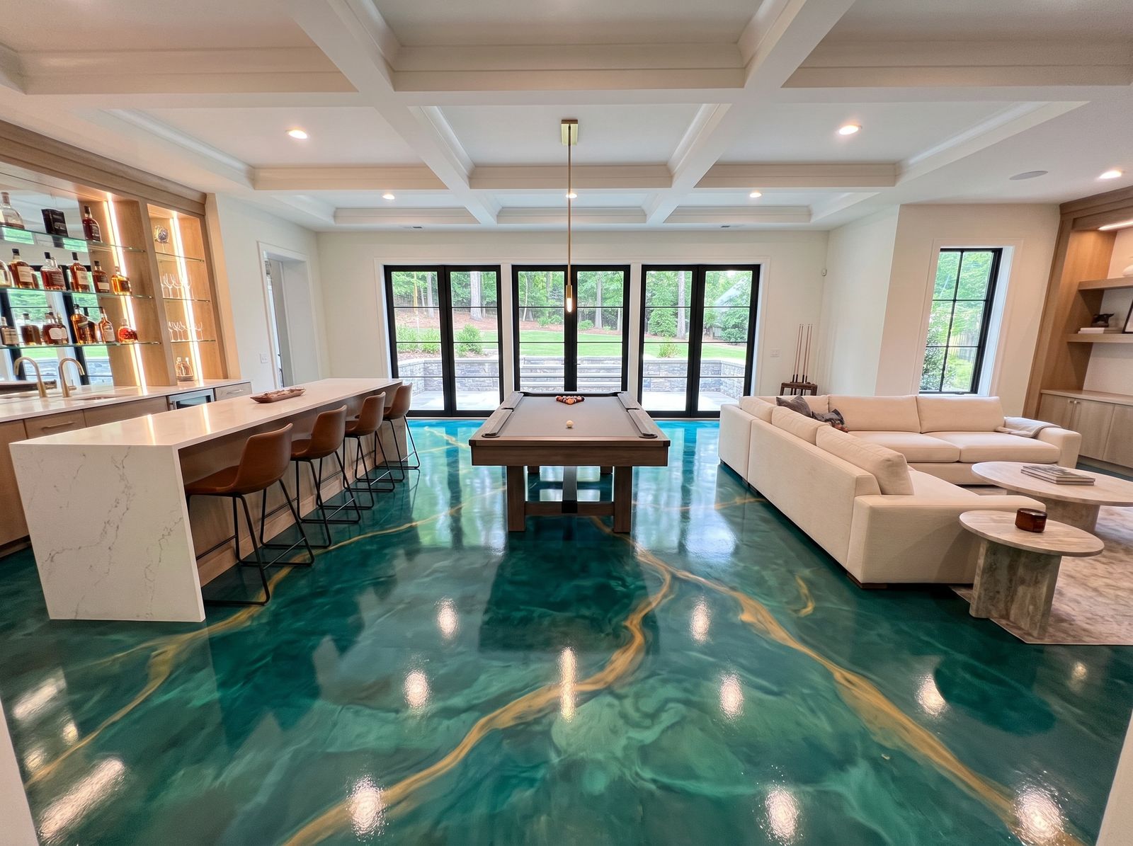 The same basement lounge with a teal and gold metallic epoxy floor