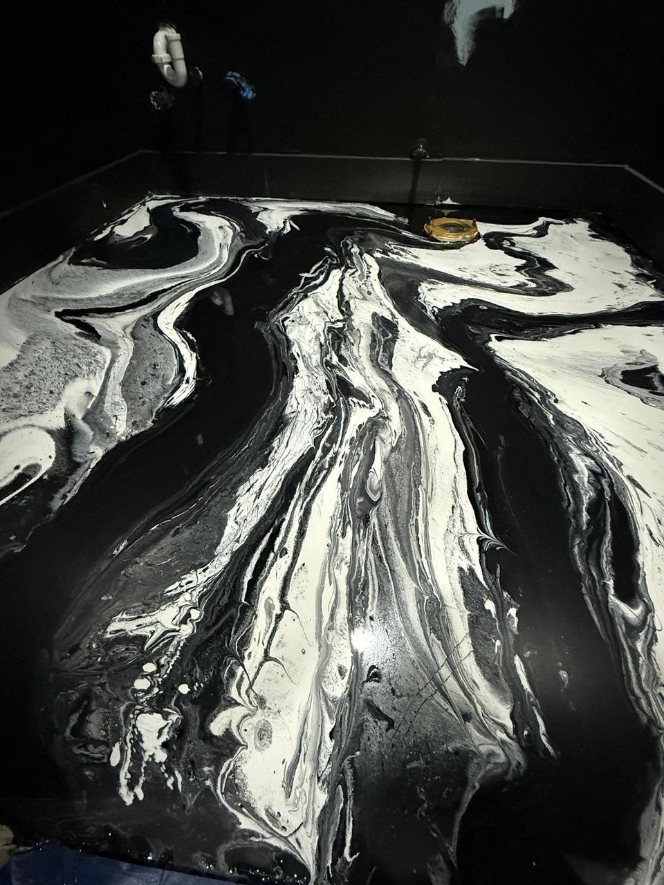 Black & white metallic, being poured — a real floor finished by Epoxy Living
