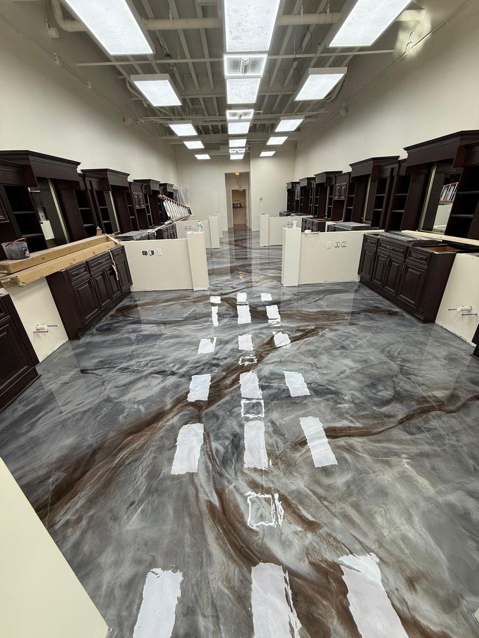 Grey & bronze metallic, cabinet showroom — a real floor finished by Epoxy Living